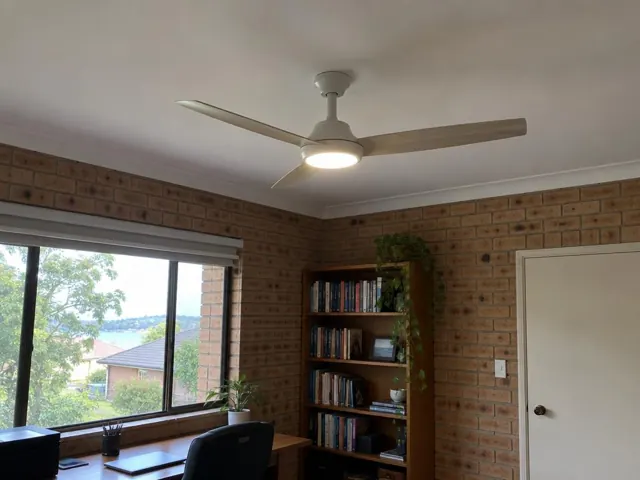Ceiling fan mounted on a white ceiling in a brick-walled home office in Point Clare